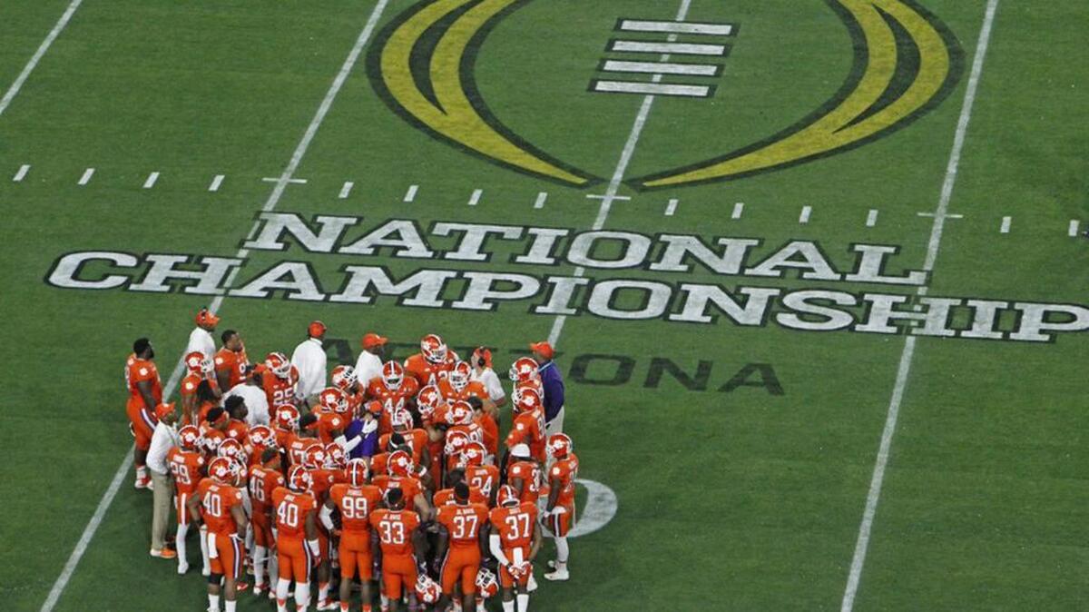 Clemson players gather with coaches during a break in action in the first half of Tuesday’s National Championship game.