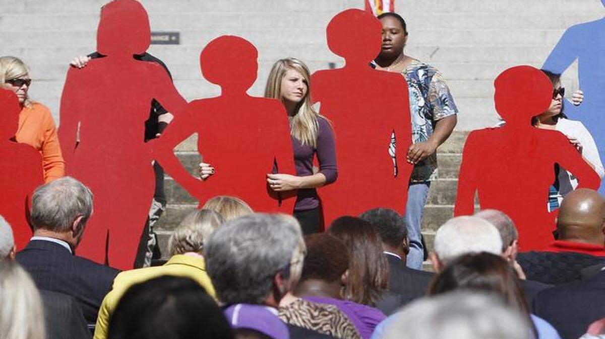 
Presenters hold silhouettes representing SC victims of domestic violence during the 2014 Silent Witness ceremony on the State House grounds in Columbia.
