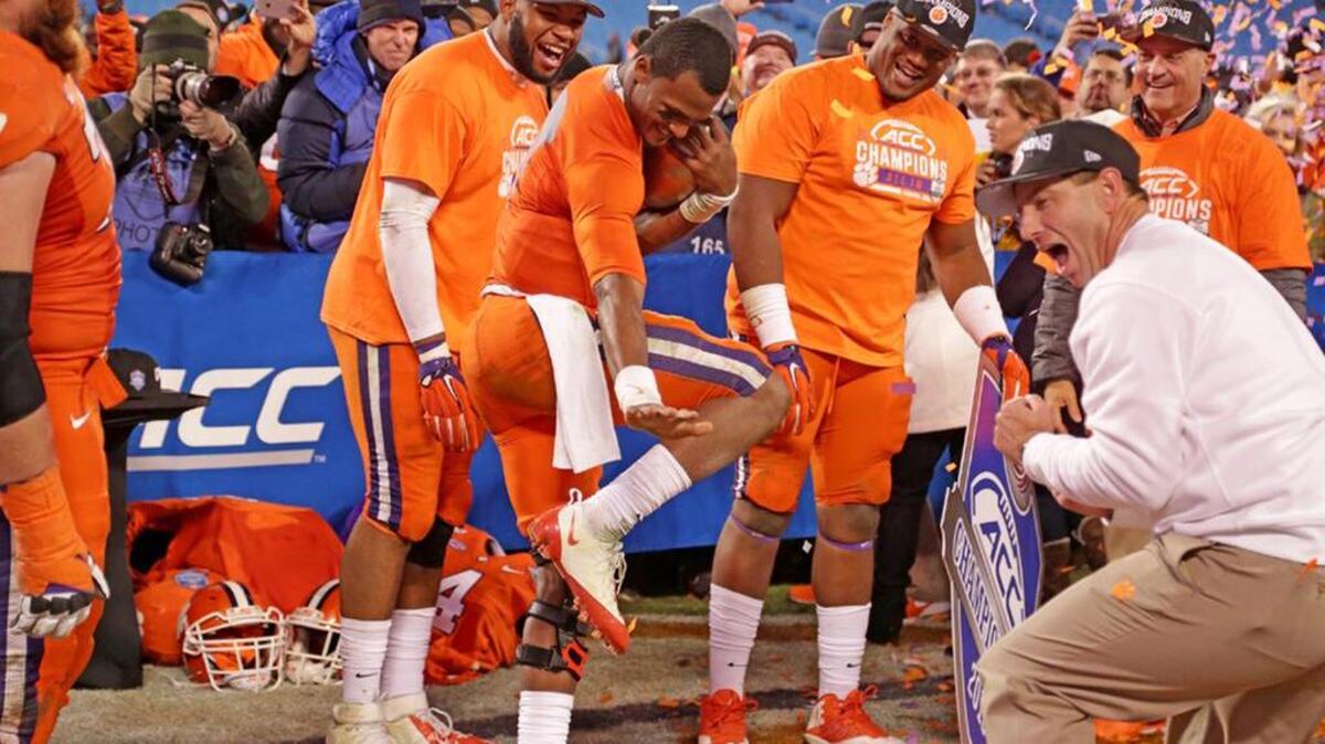Clemson quarterback Deshaun Watson does the Heisman pose as head coach Dabo Swinney celebrates their win over North Carolina to claim the ACC Championship on Dec. 5.