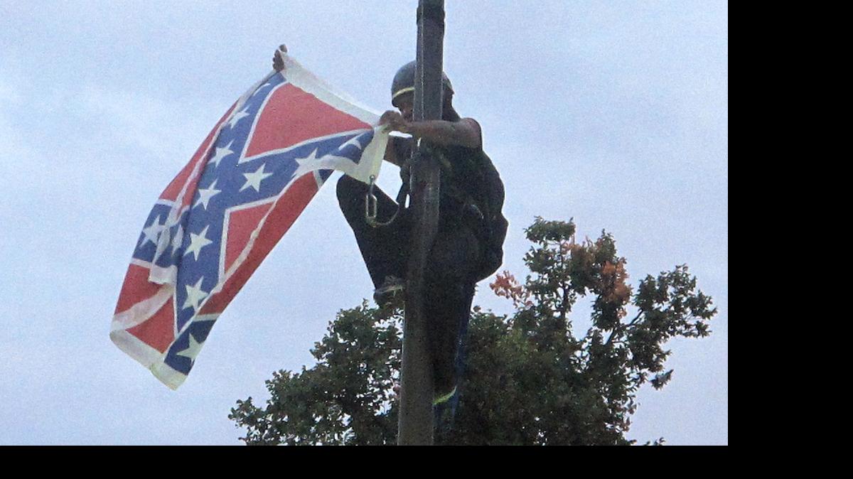
Bree Newsome of Charlotte illegally removes the Confederate battle flag on the SC State House grounds.
