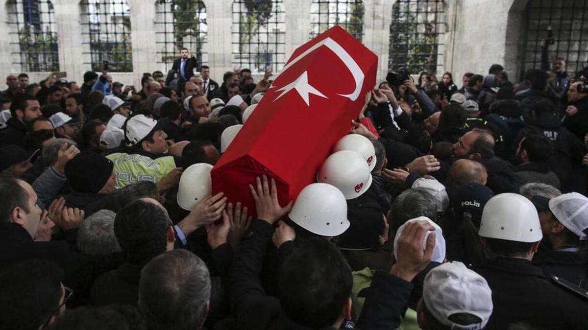 Police carry the coffin after the funeral prayers for a police officer who was killed with dozens of others in a terrorist attack Saturday in Istanbul.