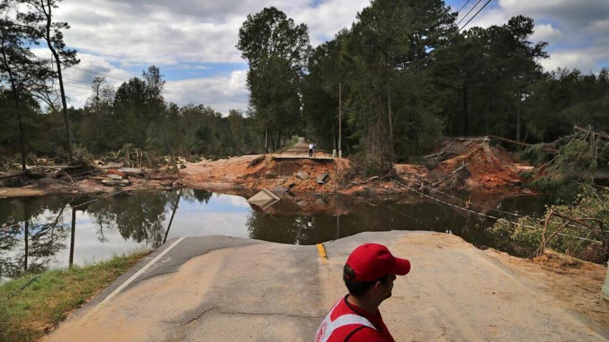
Joshua Morse, with the Salvation Army’s Emergency Disaster Services, stands near a washed-out part of Congaree Road in Lower Richland County on Monday.
