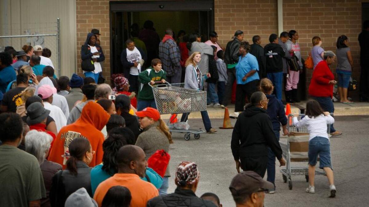 Folks in need line up outside of Harvest Hope Food Bank.