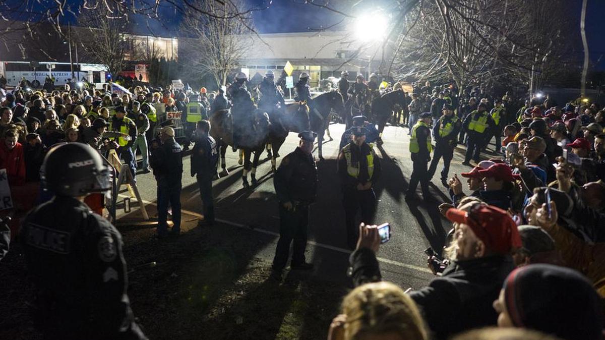 People protesting Donald Trump, left, are separated from Trump supporters, right, near the site of a campaign appearance by the Republican presidential candidate.