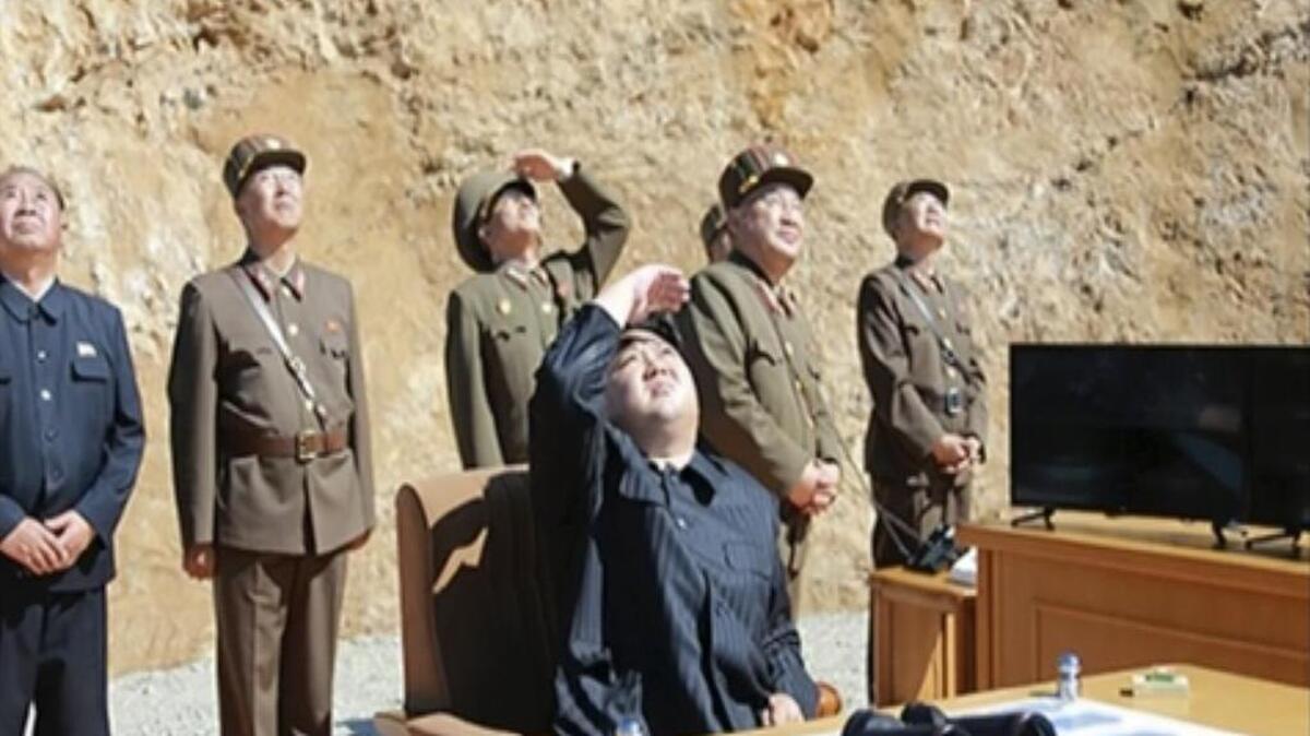 North Korea leader Kim Jung Un, center, watches the launch of a Hwasong-14 intercontinental ballistic missile in July.