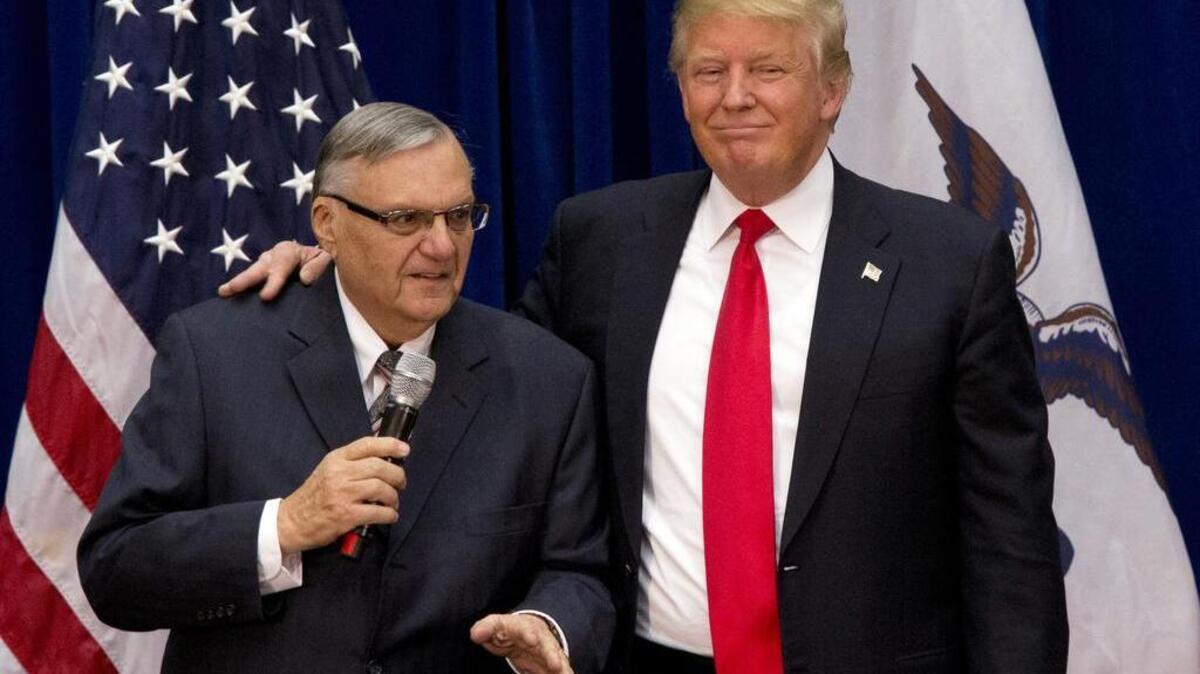 In this 2016 photo, then-Republican presidential candidate Donald Trump is joined by Joe Arpaio, then sheriff of metro Phoenix.