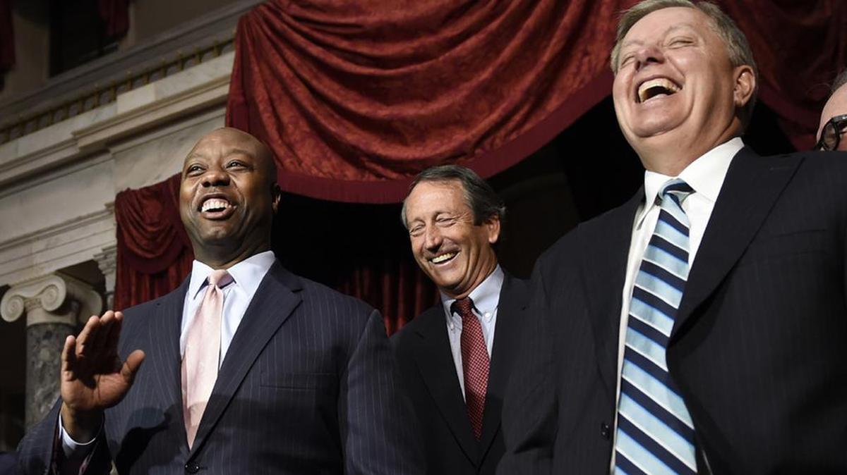 US Sens Tim Scott and Lindsey Graham, with Rep Mark Sanford in teh background