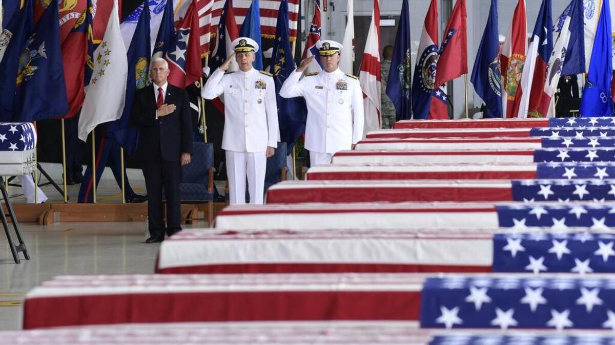 Vice President Mike Pence, left, Commander of U.S. Indo-Pacific Command Adm. Phil Davidson, center, and Rear Adm. Jon Kreitz, deputy director of the POW/MIA Accounting Agency, attend at a ceremony marking the arrival of the remains believed to be of American service members who fell in the Korean War at Joint Base Pearl Harbor-Hickam, Hawaii, Wednesday, Aug. 1, 2018. North Korea handed over the remains last week. (AP Photo/Susan Walsh)