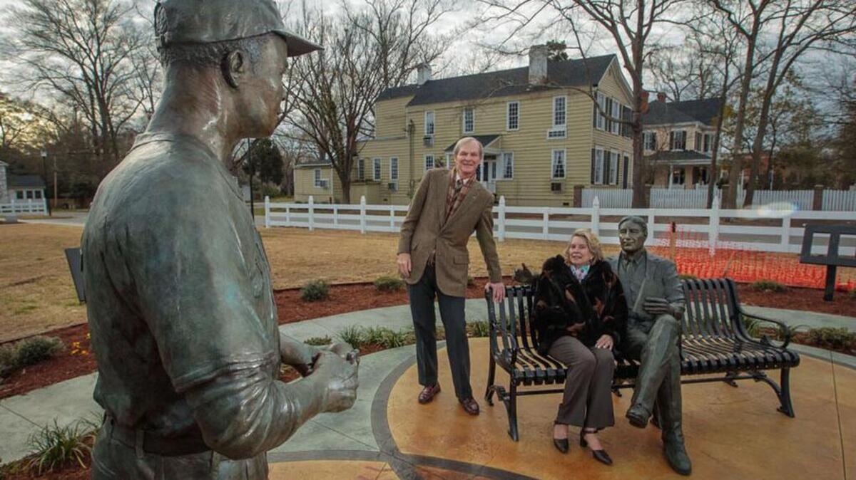 
John and Anne Rainey pose with the statues they sponsored in Camden of native sons Larry Doby, the first African-American to integrate the American Baseball League, and financier Bernard Baruch, of Jewish ancestry and an adviser to presidents.
