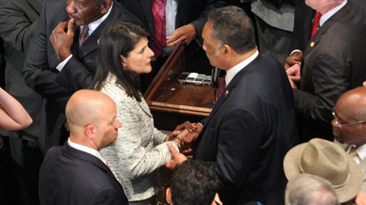 Then-SC Gov Nikki Haley talks with Jesse Jackson after signing the bill to remove the Confederate flag from the State House grounds in 2015.