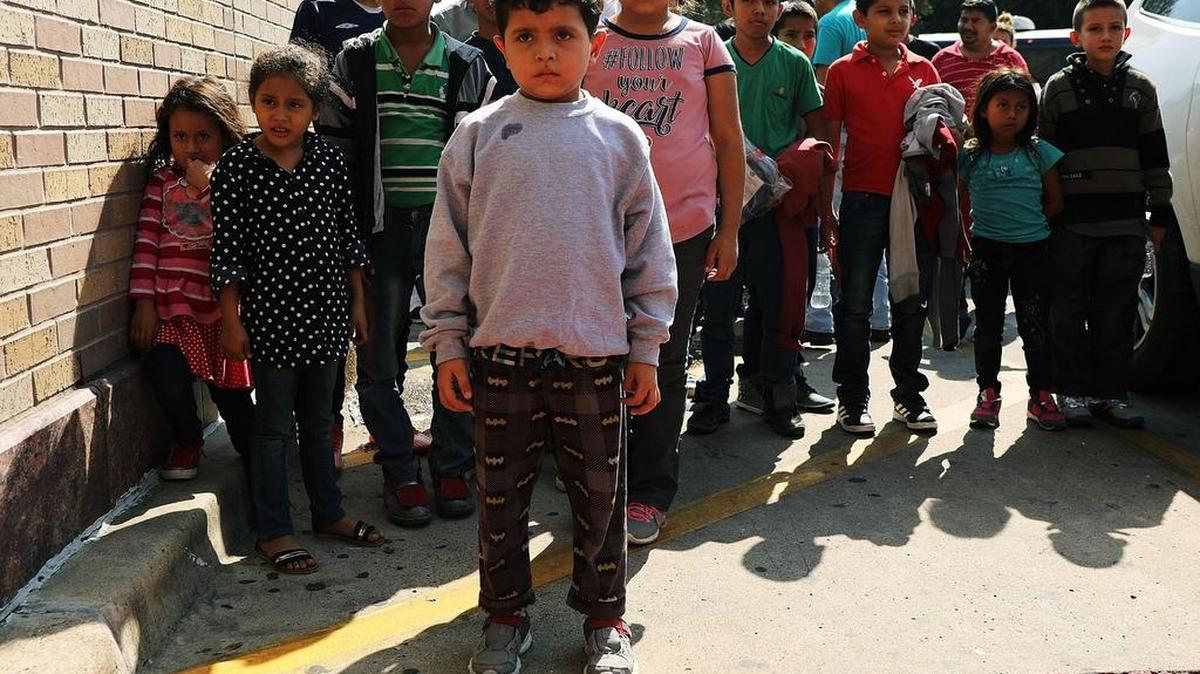Dozens of women, men and their children, many fleeing poverty and violence in Honduras, Guatamala and El Salvador, arrive at a bus station following release from Customs and Border Protection in McAllen, Texas.