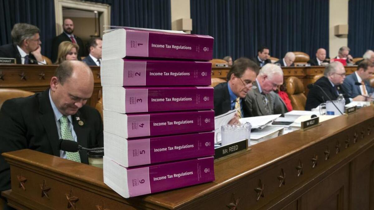 Volumes of tax regulations are stacked on the dais as the House Ways and Means Committee works thorugh the GOP tax overhaul plan.