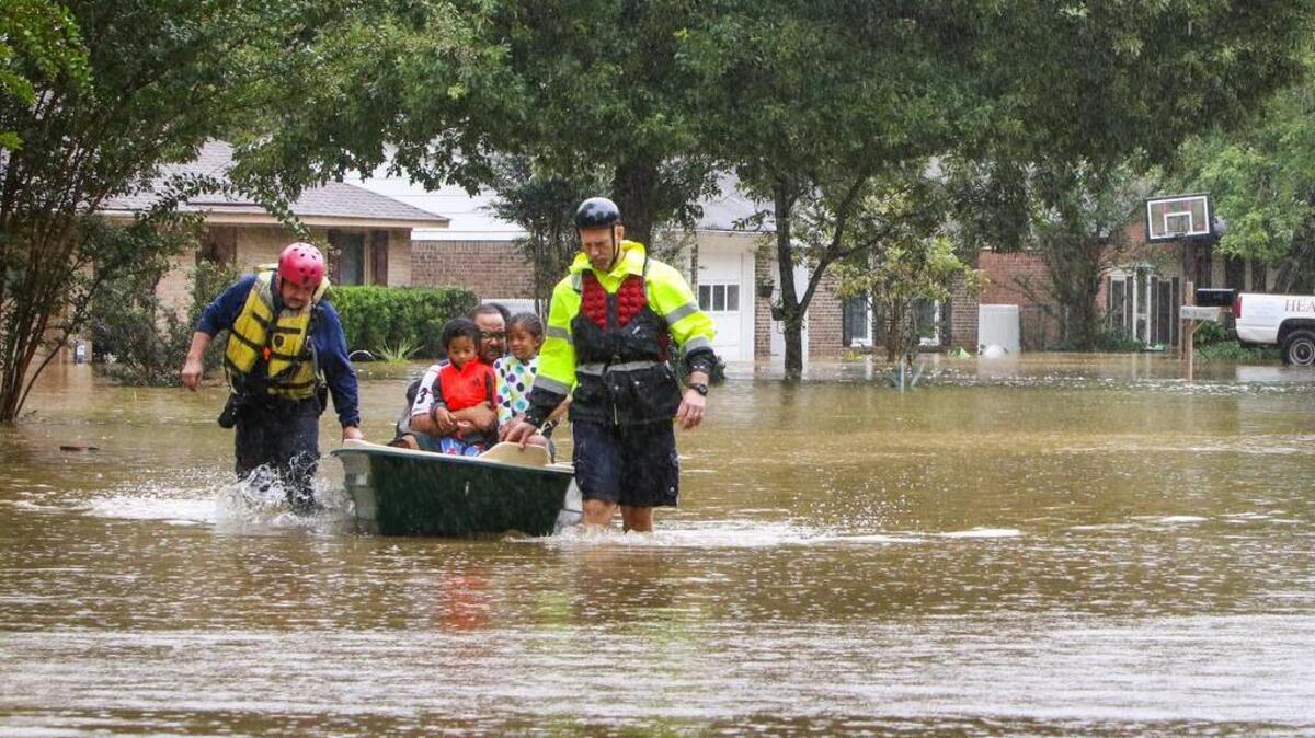 Emmanuel Jones and members of his family are rescued from their home in the Pine Glen subdivision.