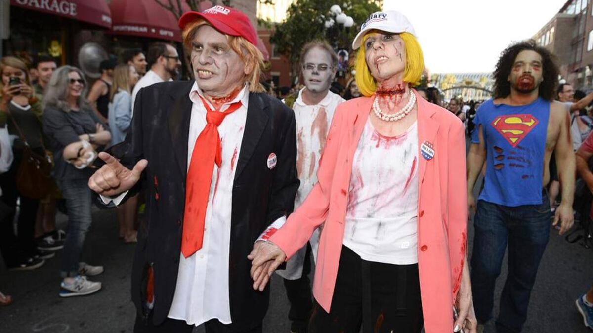 Husband and wife Dave Hester and Donna Hester, dressed as zombie Donald Trump and zombie Hillary Clinton, take part in the Zombie Walk at Comic-Con International in San Diego.