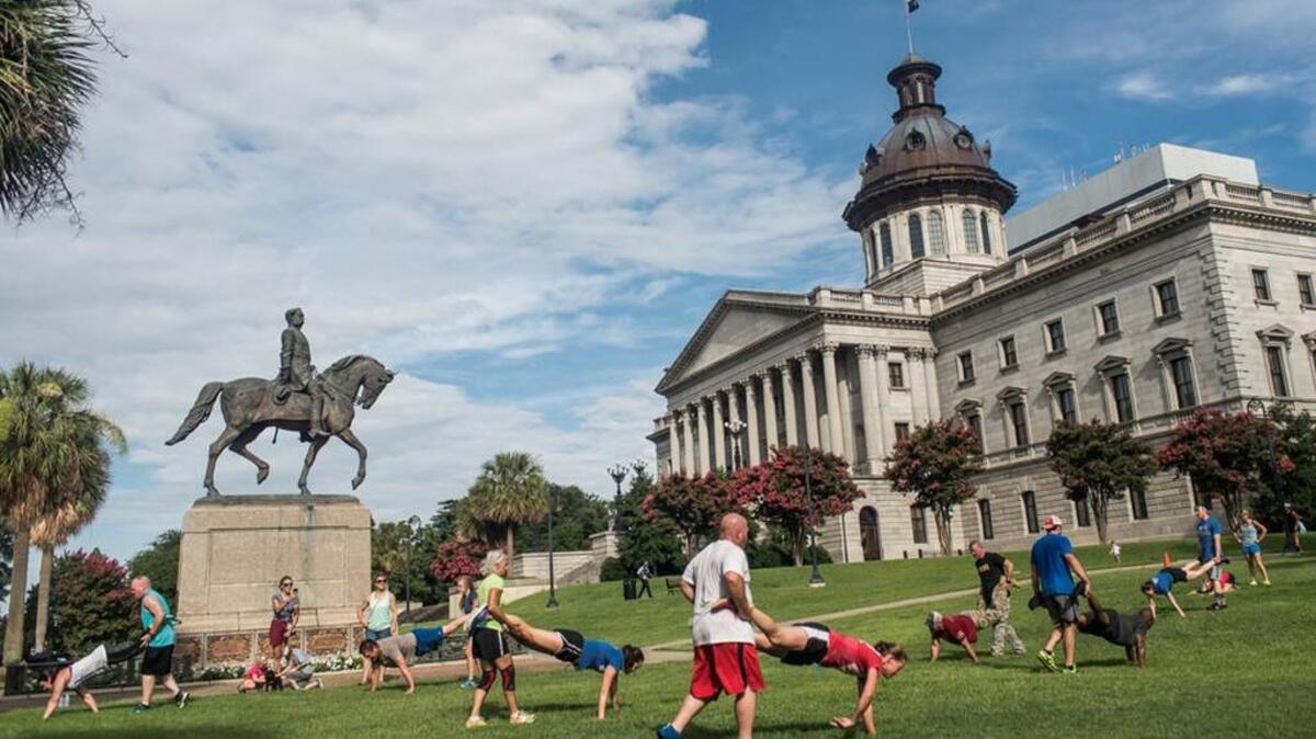 Participants tackle the “wheel barrow” station during the Ryan Rawls memorial event at the SC State House last July 4. The event is being held again Monday to honor the former Richland County sheriff’s deputy who was killed by a suicide bomber in Afghanistan in June 2012 while serving with the South Carolina National Guard.