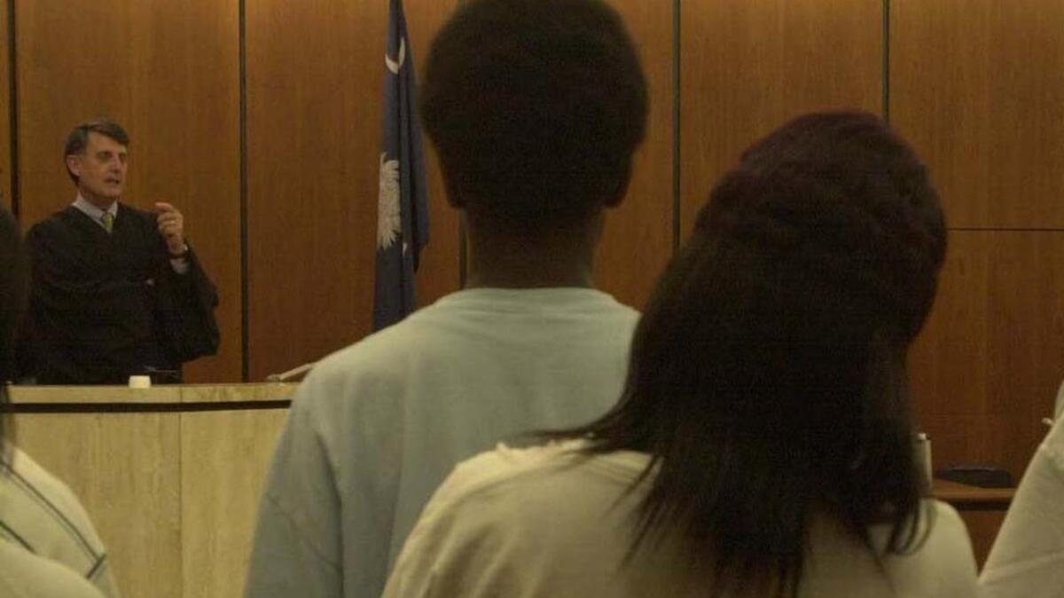 Circuit Judge Walter Brown Jr. talks to the juveniles and their parents as he hears truancy cases in Richland County’s Family Court.