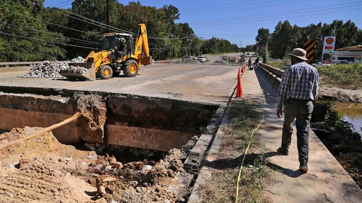 Crews work on a section of Monticello Road near Interstate 20 that was washed out by floodwaters.