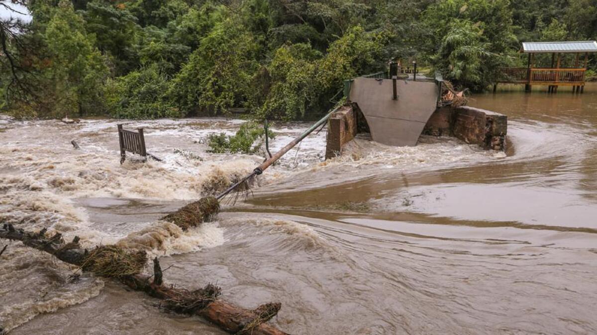 
The Twelvemile Creek floodwaters flow through the broken Gibson Pond dam in Lexington.
