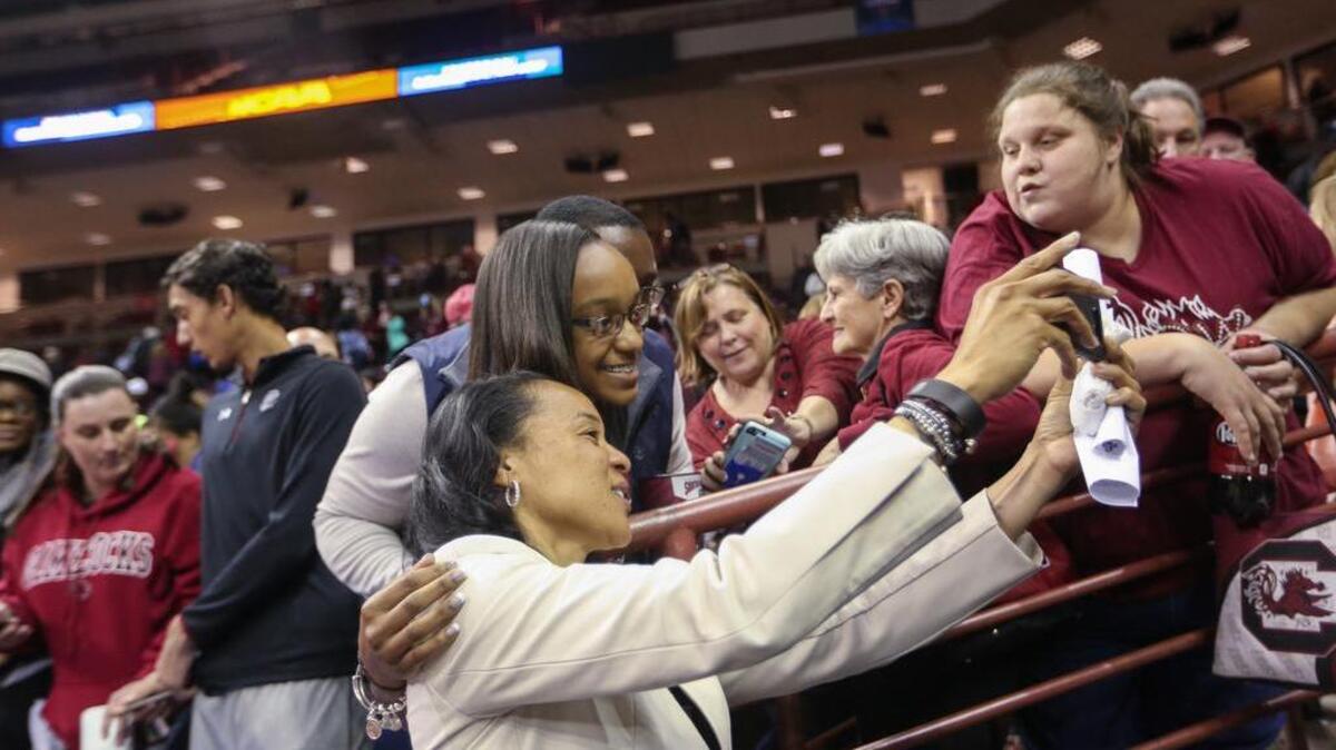 Dawn Staley signs autographs and takes photographs after beating Kansas State the second round of the NCAA Division 1 basketball championship.