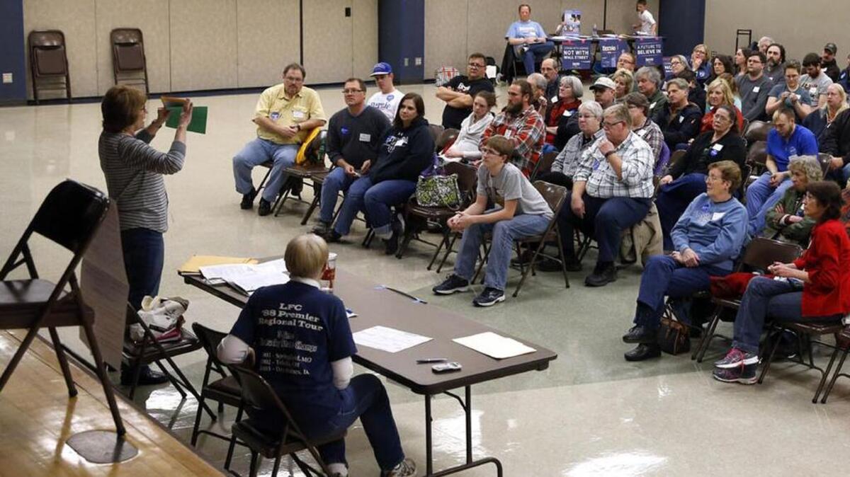 Voters listen to instructions during a Democratic Party caucus in Nevada, Iowa, on Monday.