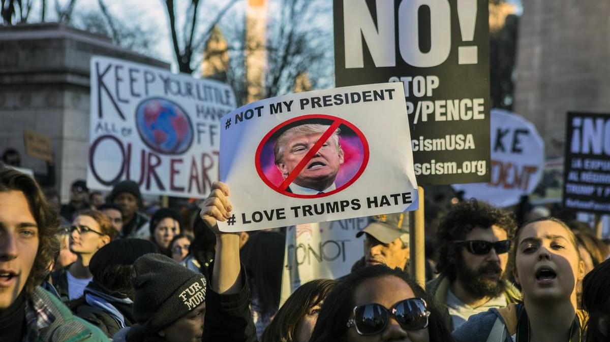 Demonstrators participate in a “Not My President’s Day” rally to protest President Donald Trump.