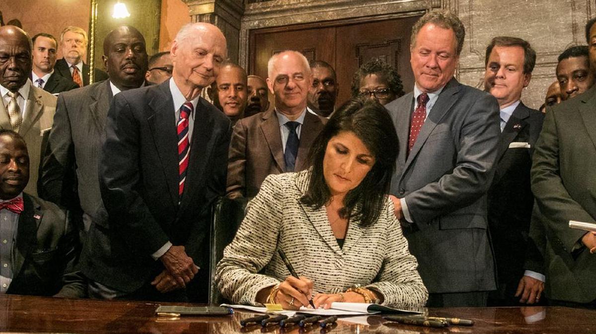 SC Gov Nikki Haley signs the bill that removed the Confederate flag from the State House lawn.