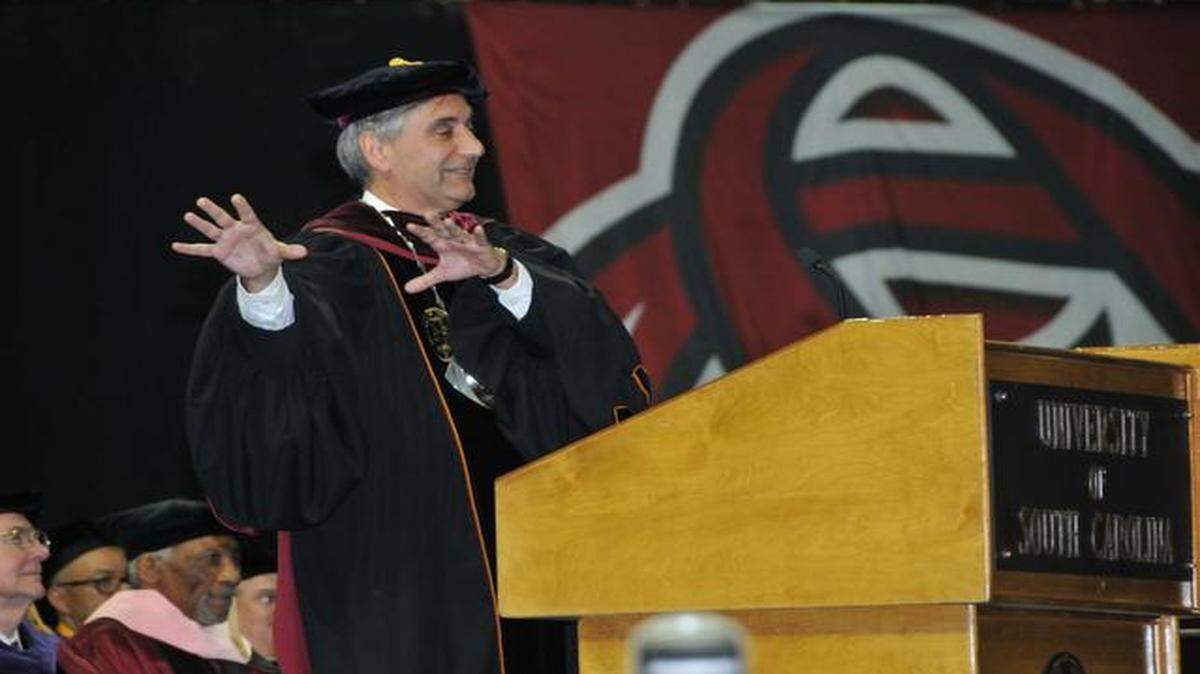 
USC President Harris Pastides leads graduates in a “GAME” and “COCK” cheer during last spring’s commencement exercises. Does the university have shared values, outside of athletics?
