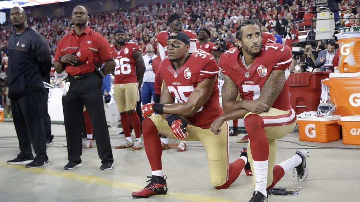 San Francisco 49ers safety Eric Reid and quarterback Colin Kaepernick (7) kneel during the national anthem.