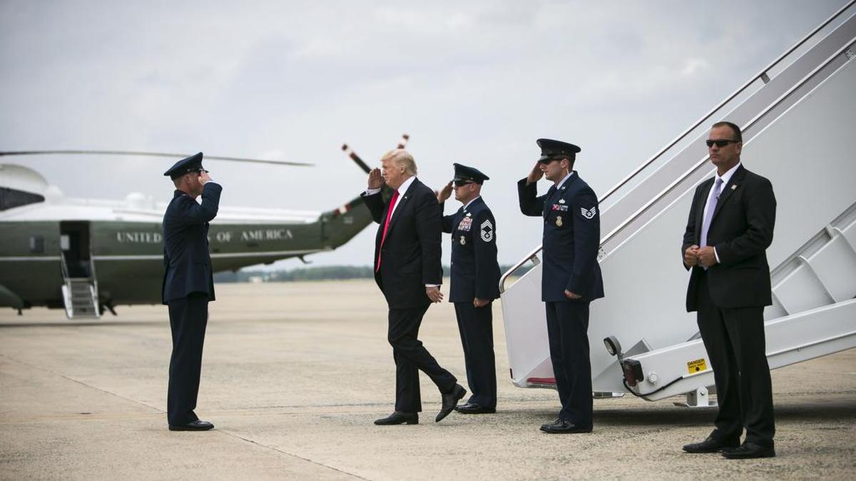 President Donald Trump is saluted by Air Force members as he arrives from Air Force One at Joint Base Andrews in Maryland on Friday.