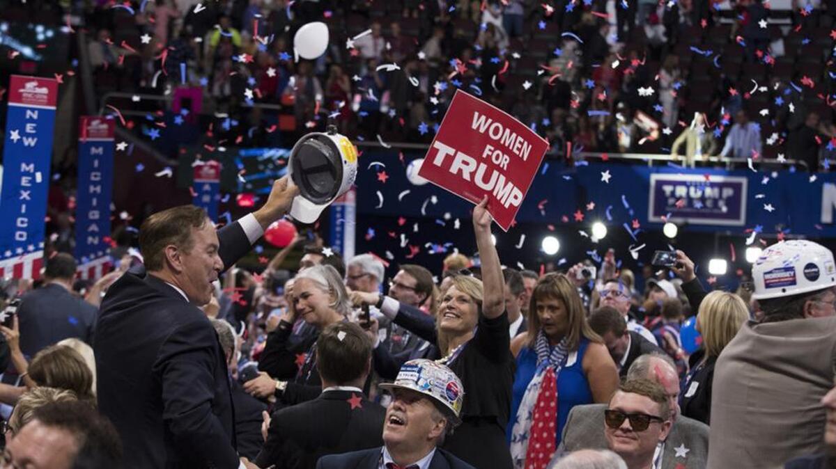 People celebrate after Republican presidential candidate Donald Trump finished speaking during the final night of the Republican National Convention.