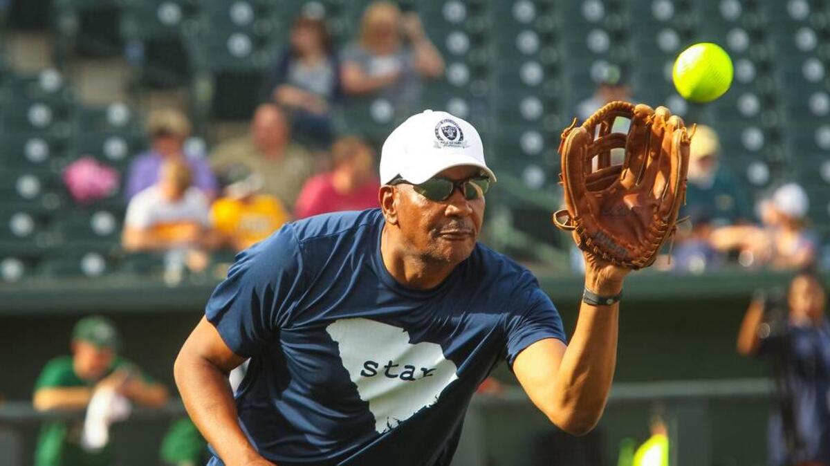 Alex English warms up for the Celebrities versus the Soldiers softball game at Spirit Communications Park in June.