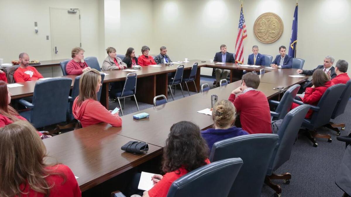 Teachers and supporters gather with legislators to discuss the proposed “Teachers’ Bill of Rights” on Dec. 12.