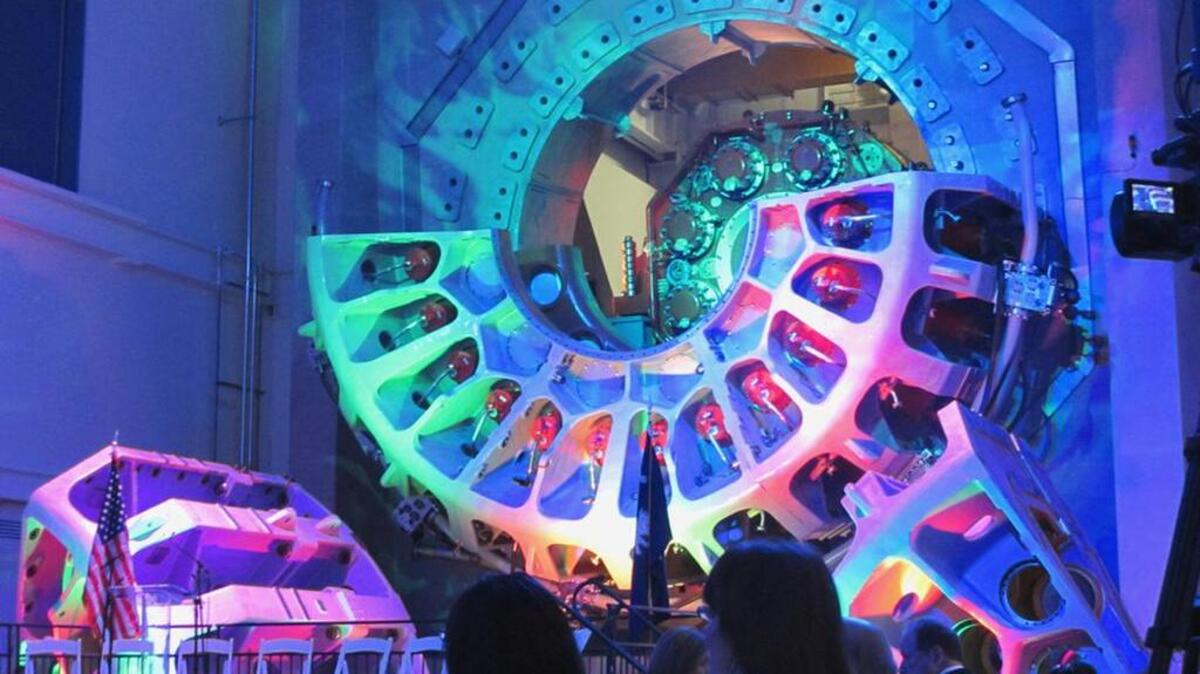 A 15-megawatt wind turbine drivetrain testing rig is bathed in colored lights inside Clemson University’s Energy Systems Innovation Center in North Charleston just before a dedication ceremony for the center.