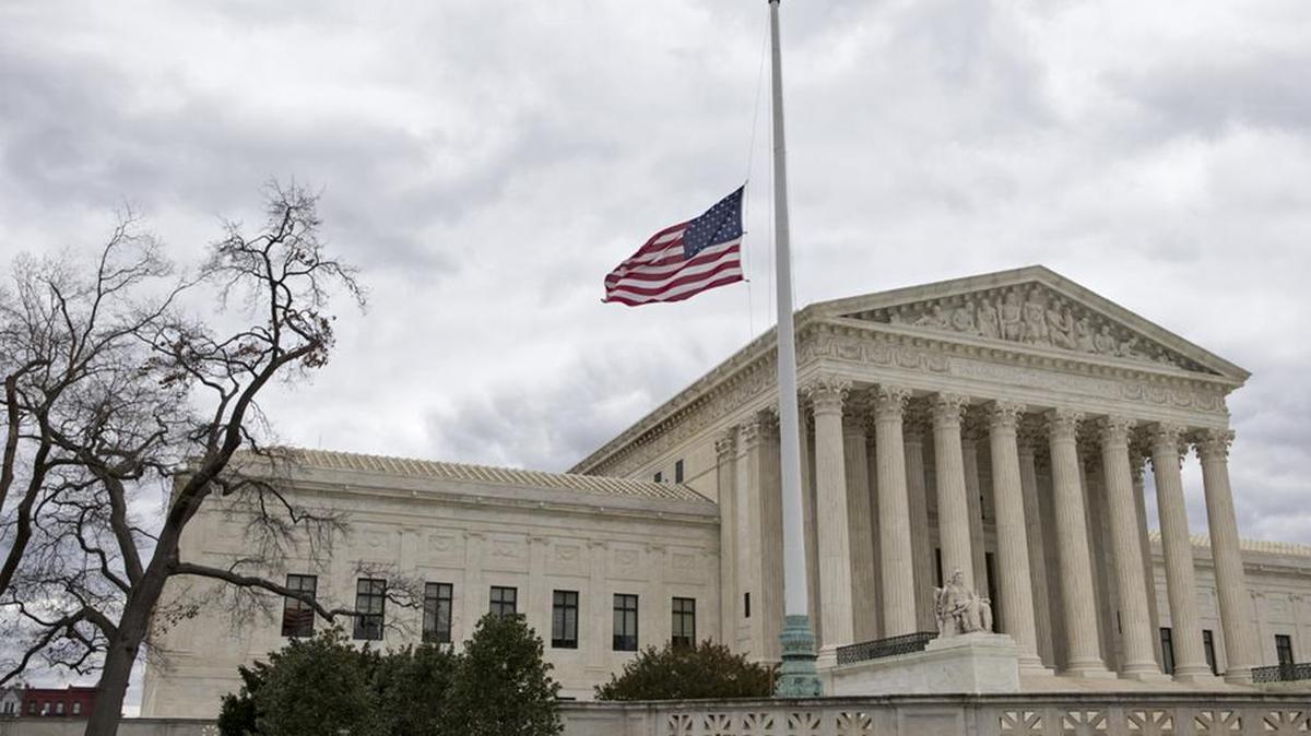 A flag in the US Supreme Court building’s front plaza flies at half-staff in in honor of the late Justice Antonin Scalia in this February 2016 photo.