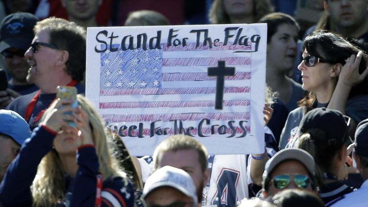 Fans have their say about the national anthem at an NFL football game between the New England Patriots and Carolina Panthers.