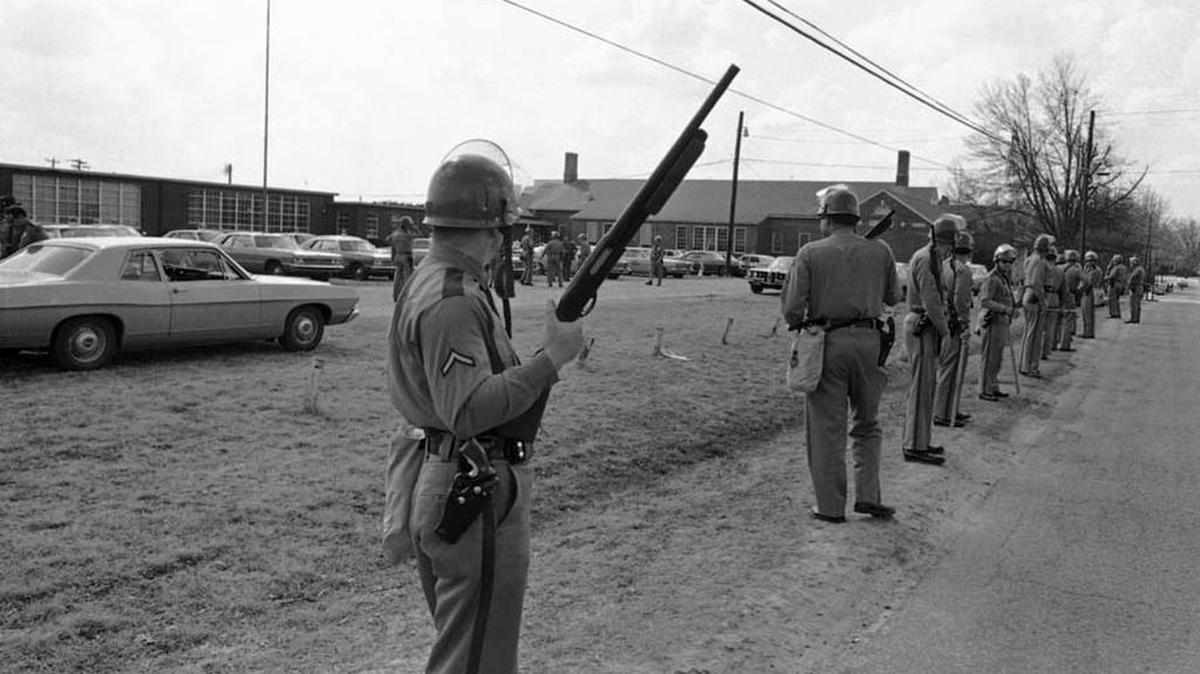 The SC Highway Patrol stands guard at Lamar High School in 1970 the day after a crowd of white adults overturned two school buses and clashed violently with state troopers to protest a school desegregation order.
