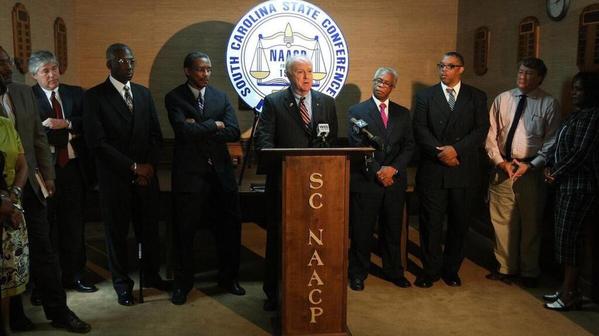 Former SC Elections director Rusty DePass appears at a 2009 NAACP news conference to apologize for a Facebook post that linked an escaped gorilla with  the ancestors of First Lady Michelle Obama. To his left is SC  NAACP President Lonnie Randolph.