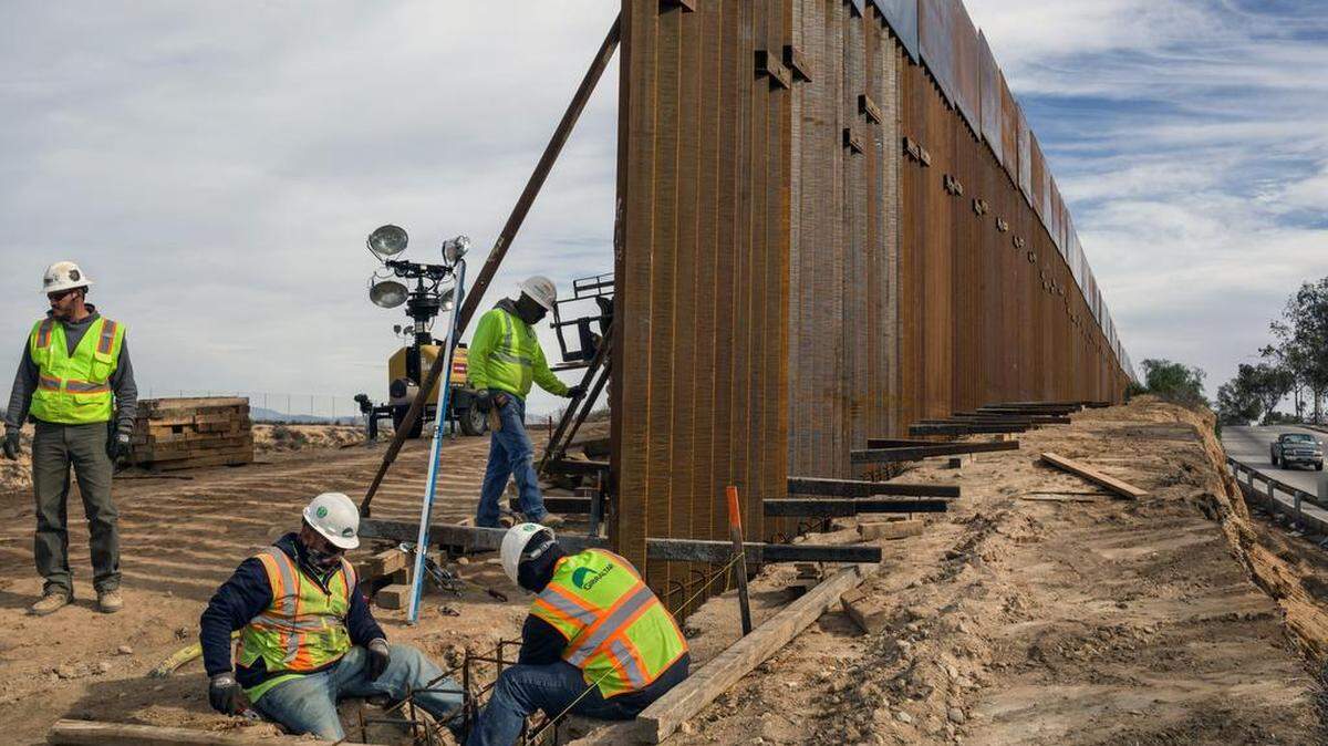 Contractors work on expanding a portion of the border wall between San Diego and Tijuana in 2018. On Oct. 9, an appellate court panel ruled that President Trump illegally used $2.5 billion in Defense Department funds to build sections of border wall in California, Arizona and New Mexico.