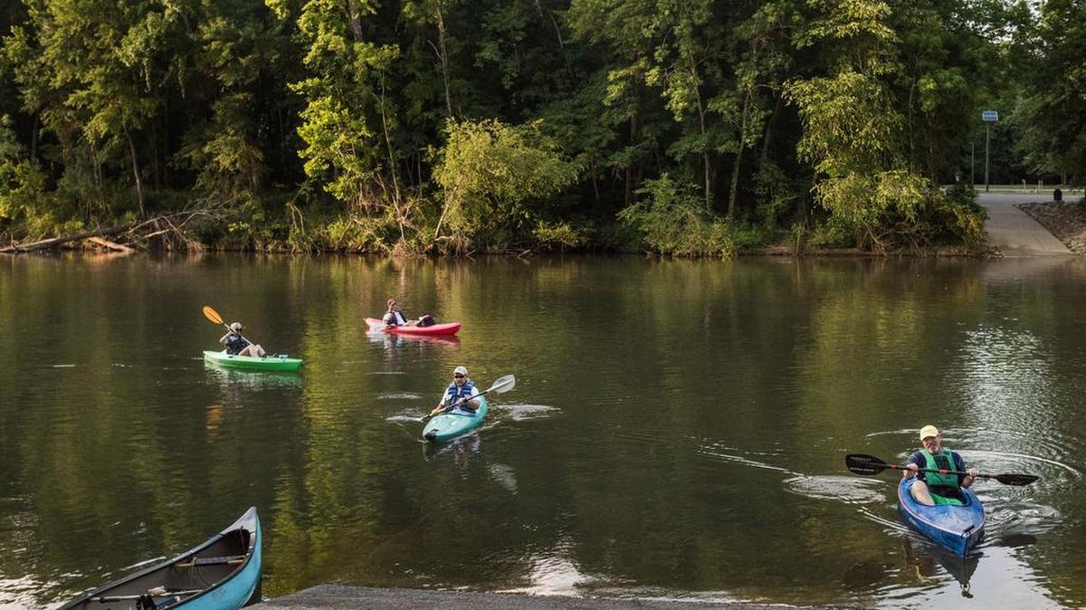 Kayakers land their boats on the Saluda River at Hopes Ferry Landing at Saluda Shoals Park.