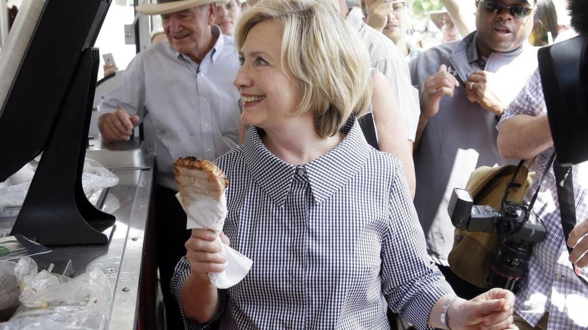 
Democratic presidential candidate Hillary Rodham Clinton buys a pork chop during a visit to the Iowa State Fair.
