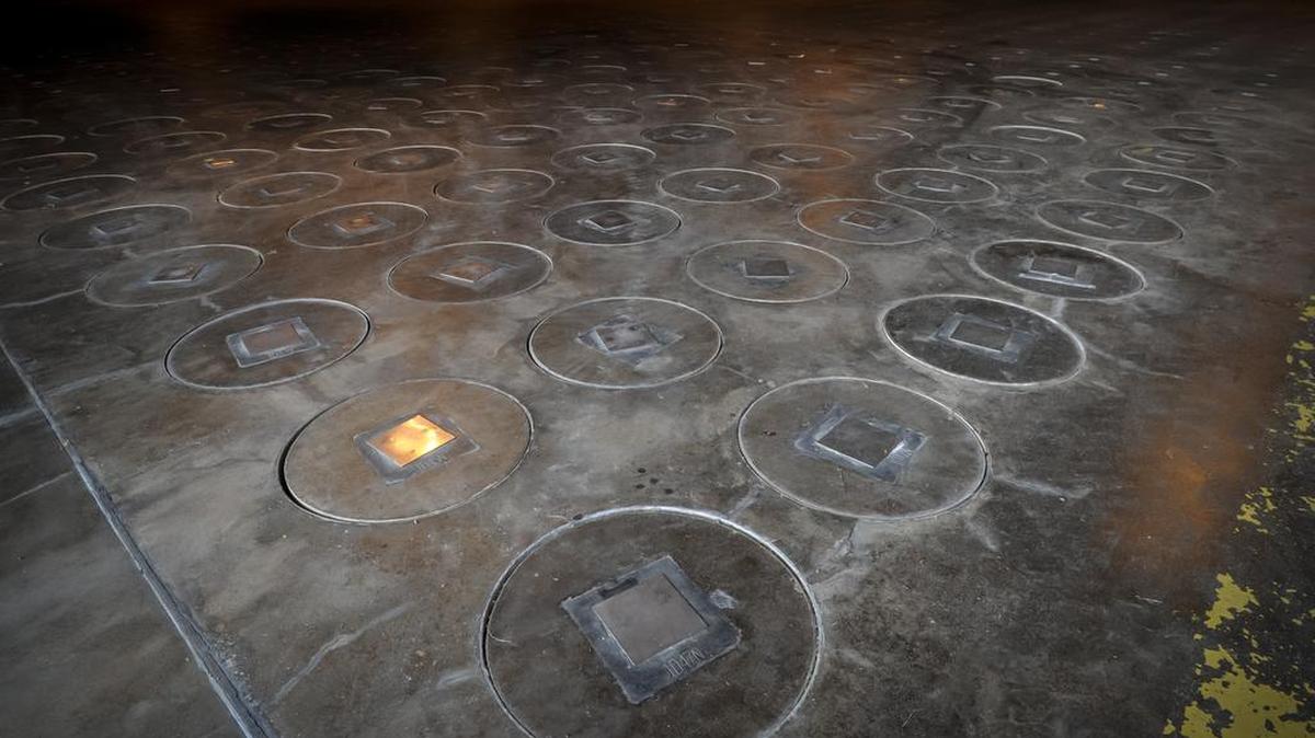 Radioactive waste, sealed in large stainless steel canisters, is stored under a five-feet of concrete in a storage building at the Savannah River Site near Aiken.