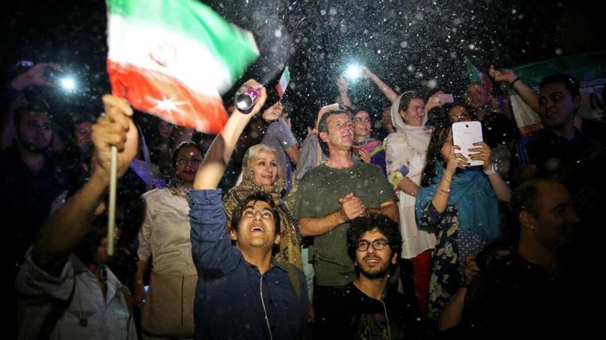 
Jubilant Iranians cheer and spray artificial snow during street celebrations following a landmark nuclear deal with the world’s major powers.
