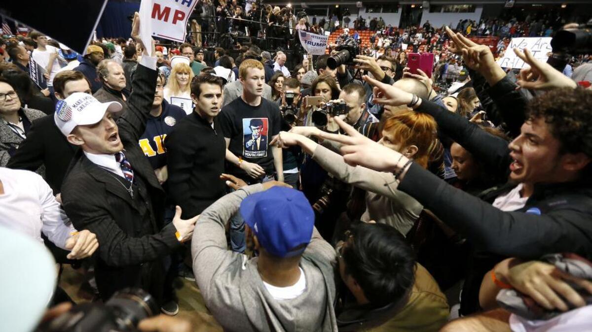 Supporters of President-Elect Donald Trump, left, face off with protesters at a rally earlier this year.