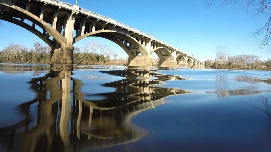 The river bottom of the Congaree River near the Gervais Street bridge is coated with coal tar.