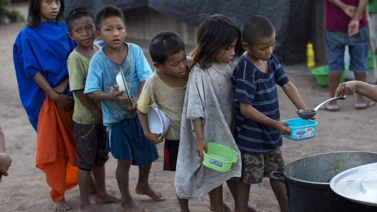 Students line up for a serving of banana porridge provided by a government food program targeting public schools a section of Peru where 80 percent of children are malnurished.
