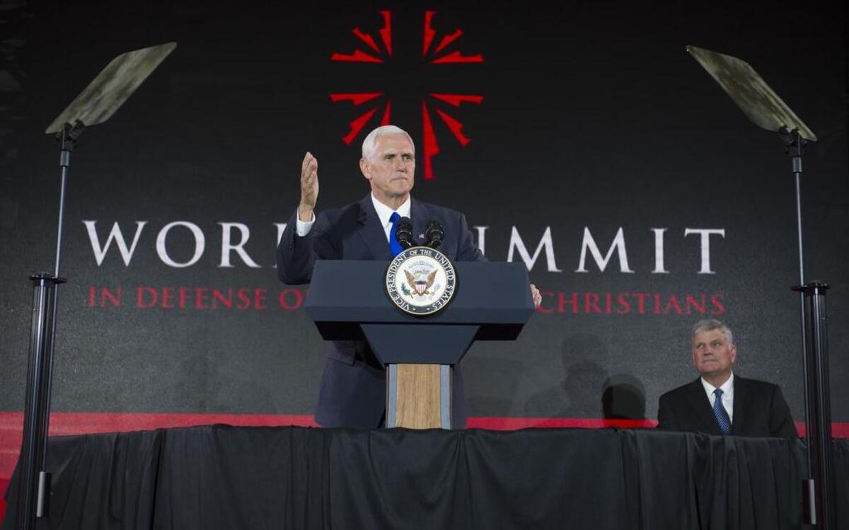 Vice President Mike Pence addresses the World Summit in Defense of Persecuted Christians as Franklin Graham watches.