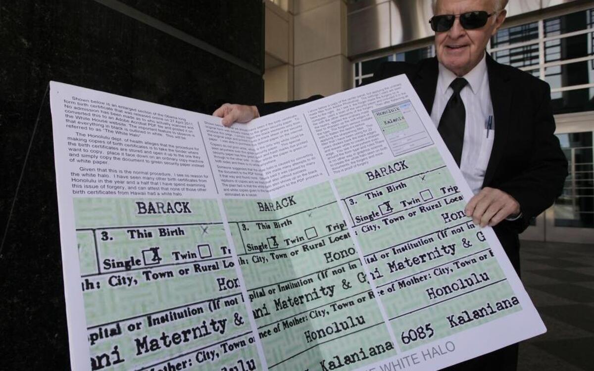 Paul Irey displays enlarged copies of what he claims is President Barack Obama’s forged birth certificate in this 2013 photo.