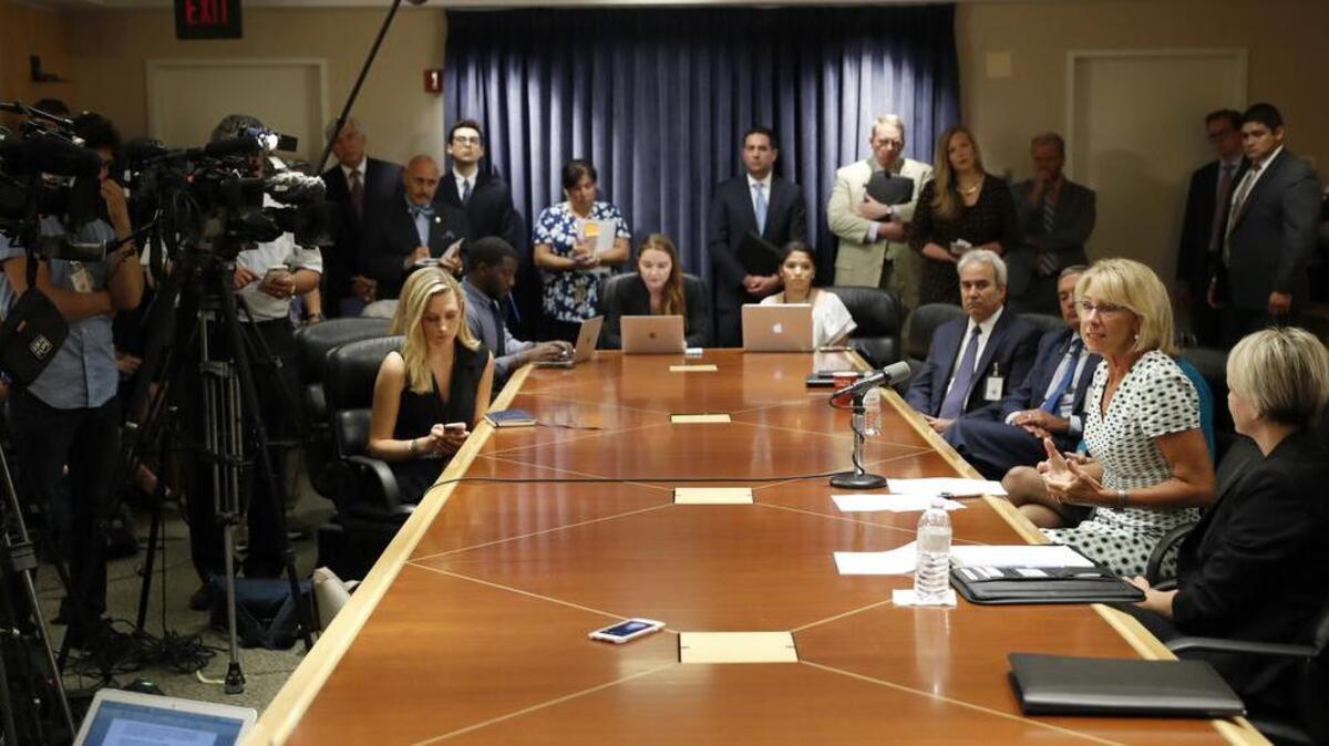 US Education Secretary Betsy DeVos, second from right, speaks with the media after a series of listening sessions about campus sexual violence in July.