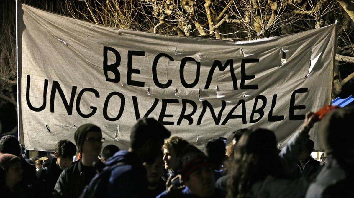 Protestors against a scheduled speaking appearance by Breitbart News editor Milo Yiannopoulos march on the University of California at Berkeley campus. The event was canceled out of safety concerns after protesters hurled smoke bombs, broke windows and started a bonfire.