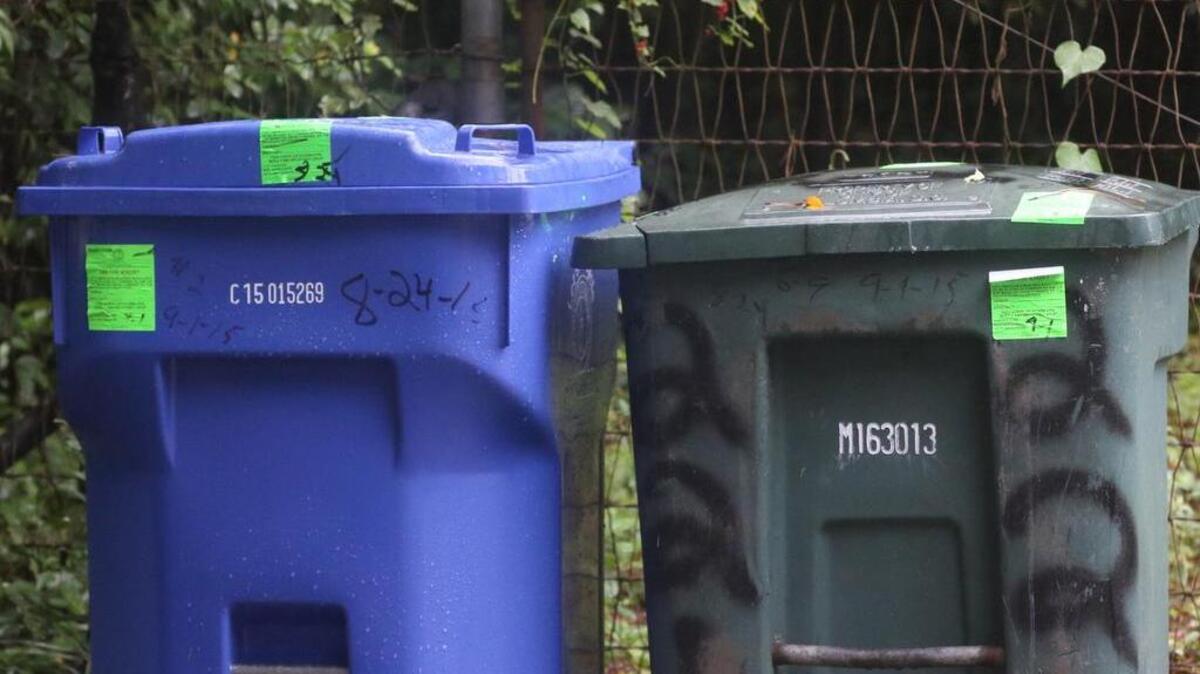 
Trash bins at a rental property in Shandon are marked with violations for being left on the street for extended periods of time.
